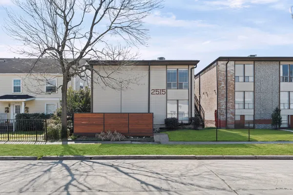 a front view of a house with a yard and a garden