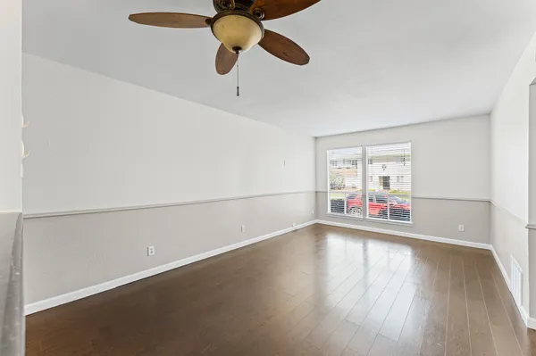a view of room with window and wooden floor