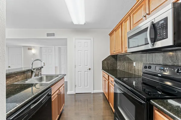 a kitchen with a sink and stainless steel appliances