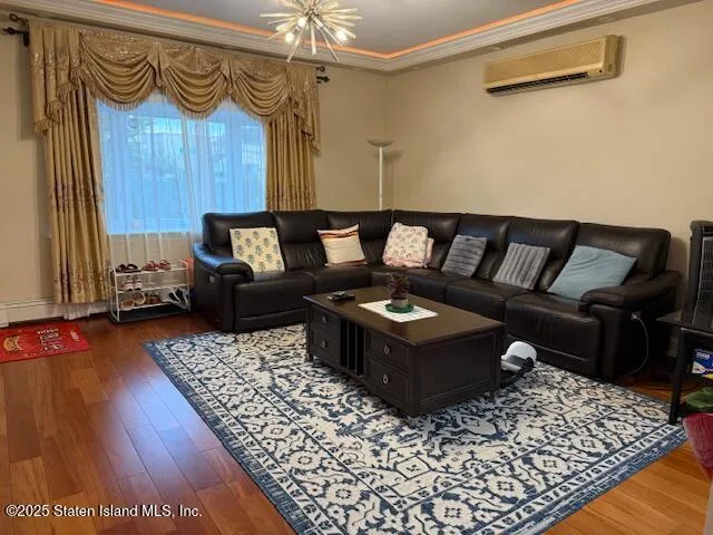 a living room with a couch and a wooden floor