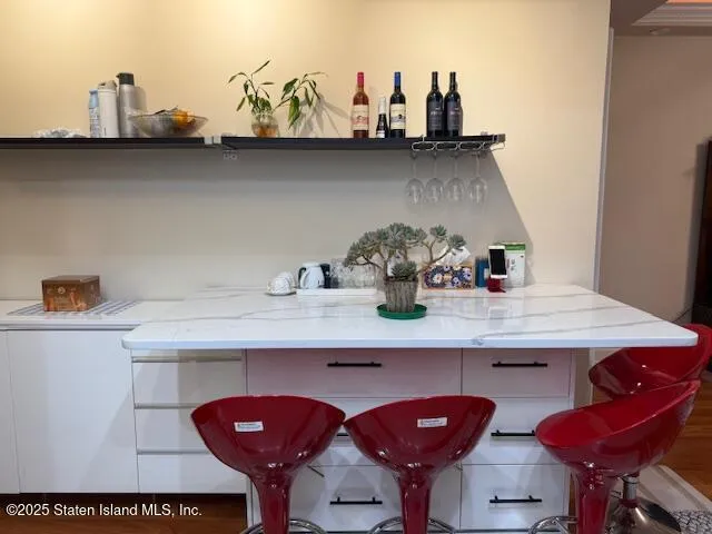 a kitchen with stainless steel appliances a sink a stove a refrigerator cabinets and a dining table