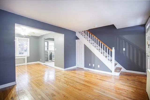 a view of an entryway with wooden floor
