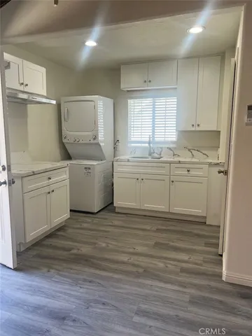 a room with white cabinets and sink
