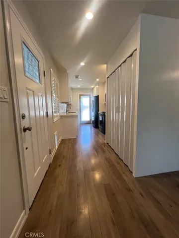 a view of a hallway with wooden floor