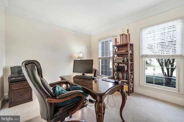a living room with furniture a rug and a lamp