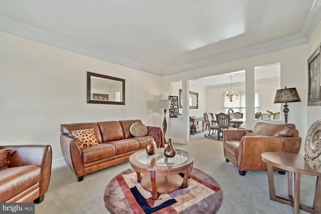 a view of a dining room with furniture and chandelier