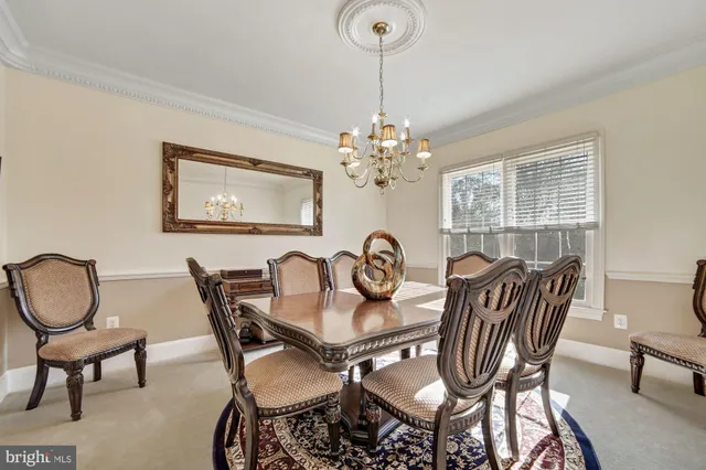 a kitchen with stainless steel appliances kitchen island granite countertop a refrigerator a stove a sink dishwasher and wooden cabinets with wooden floor