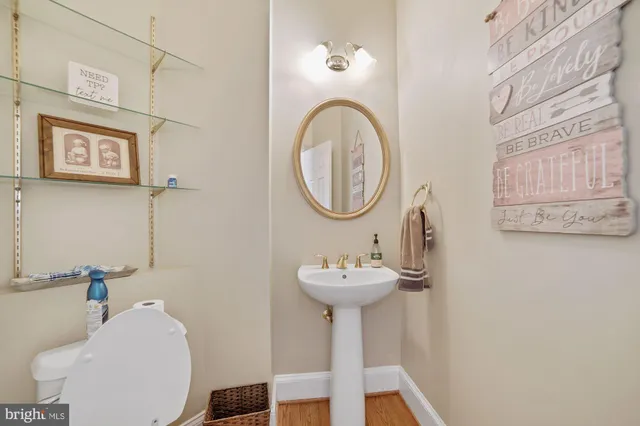 a bathroom with a sink toilet double vanity and shower