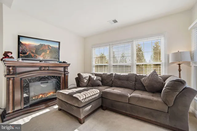 a bathroom with a tub a sink and a window
