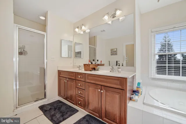 a bathroom with a sink a large mirror and a toilet