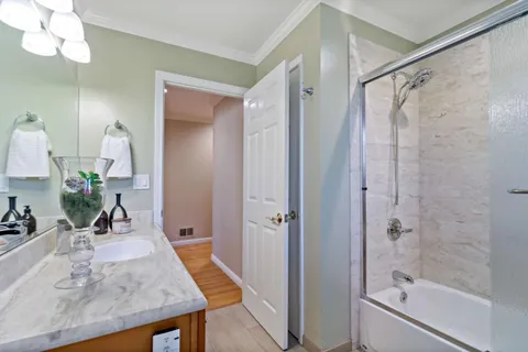 a kitchen with granite countertop stainless steel appliances a stove sink and cabinets