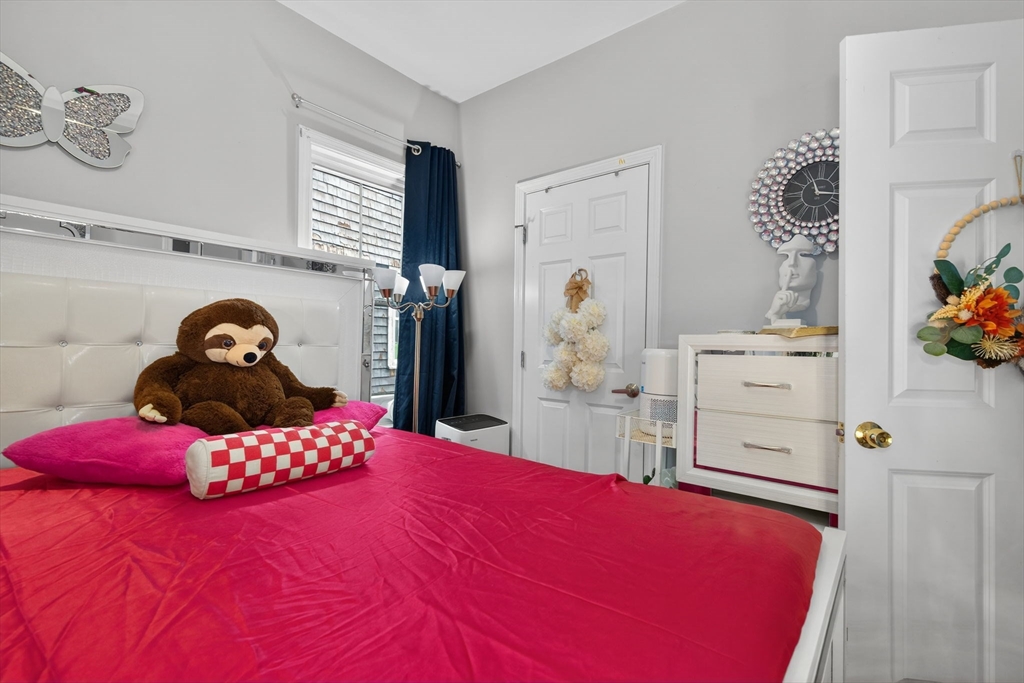 1684 North Shore Road Revere, MA 02151 - Photo 11 of 39 a bedroom with a bed and a dresser