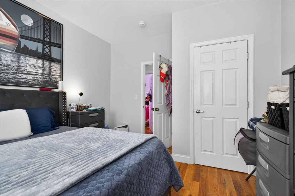 1684 North Shore Road Revere, MA 02151 - Photo 13 of 39 a bedroom with a bed and a dresser