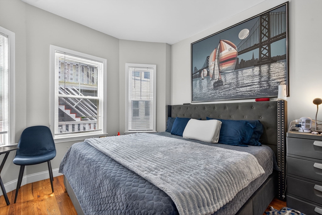 1684 North Shore Road Revere, MA 02151 - Photo 14 of 39 a bedroom with a bed and a painting on the wall