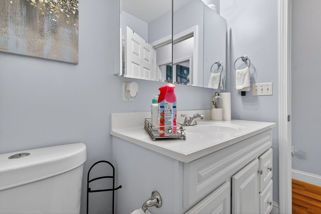 1684 North Shore Road Revere, MA 02151 - Photo 15 of 39 a bathroom with a sink a toilet and mirror