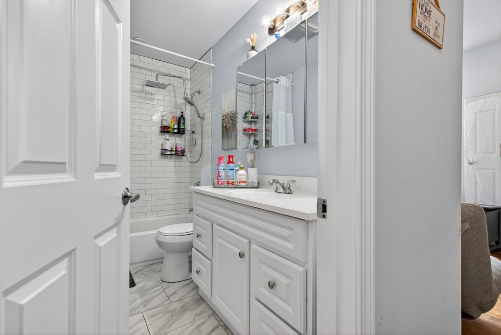 1684 North Shore Road Revere, MA 02151 - Photo 16 of 39 a bathroom with a sink toilet vanity and shower