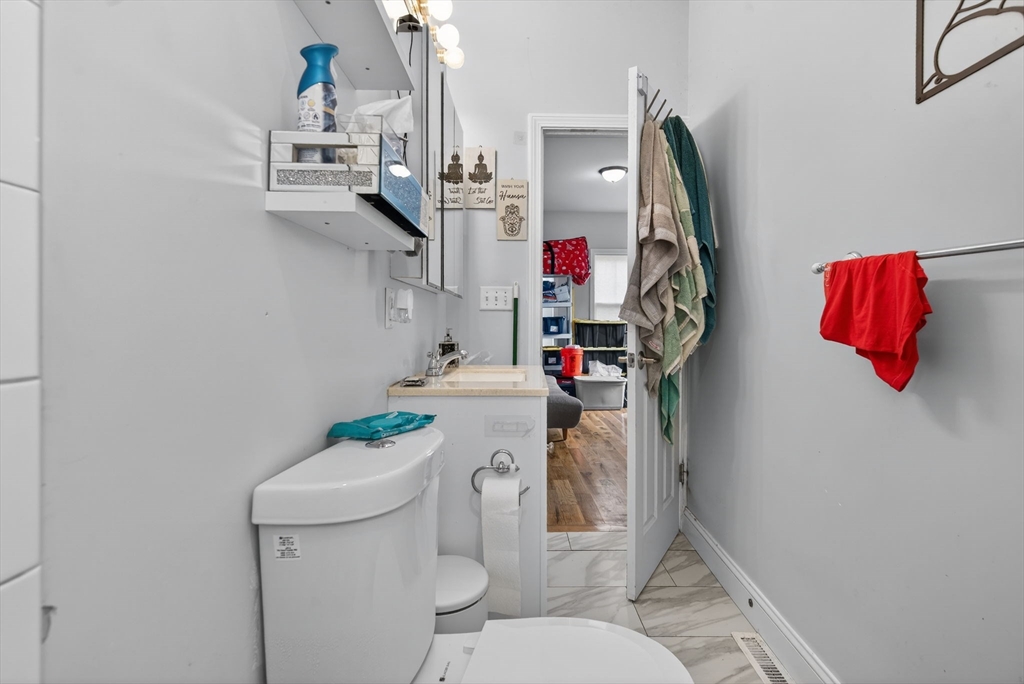 1684 North Shore Road Revere, MA 02151 - Photo 18 of 39 a bathroom with a sink vanity mirror and toilet