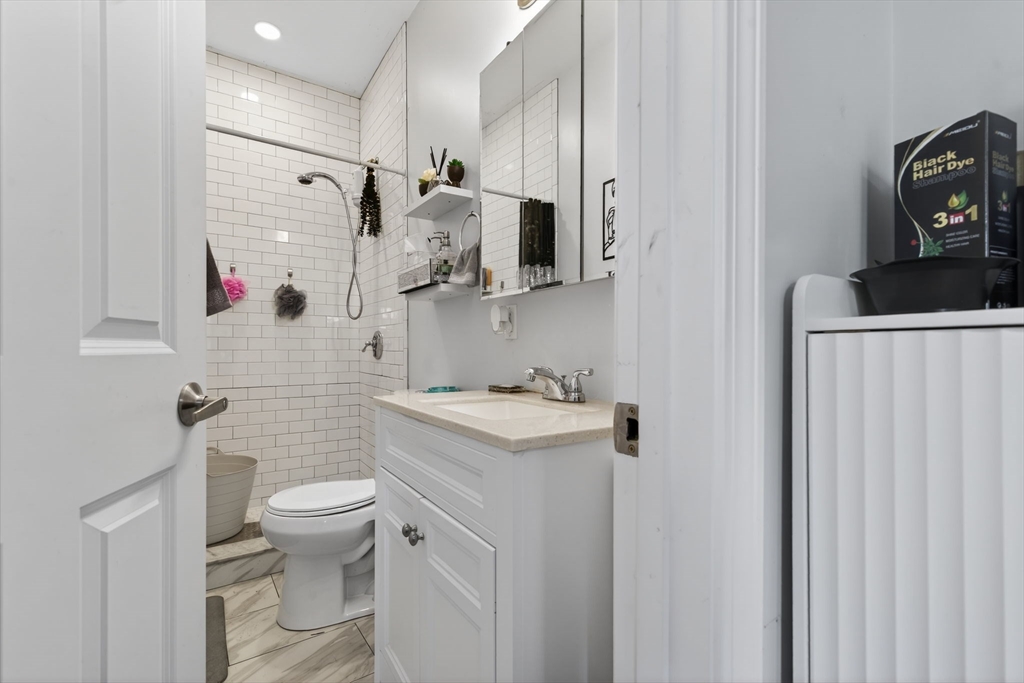 1684 North Shore Road Revere, MA 02151 - Photo 19 of 39 a bathroom with a granite countertop sink toilet and shower