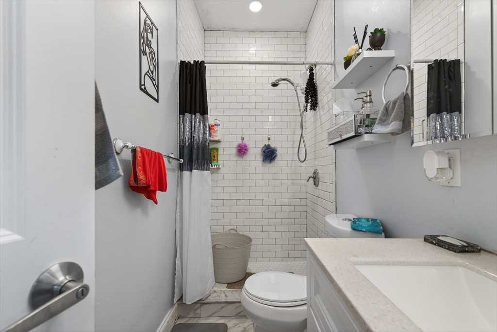 1684 North Shore Road Revere, MA 02151 - Photo 20 of 39 a bathroom with a sink toilet and shower