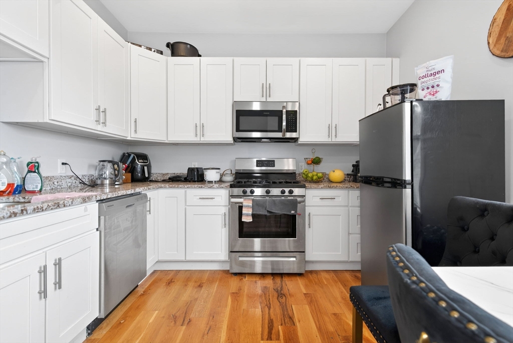 1684 North Shore Road Revere, MA 02151 - Photo 21 of 39 a kitchen with a sink a refrigerator and cabinets