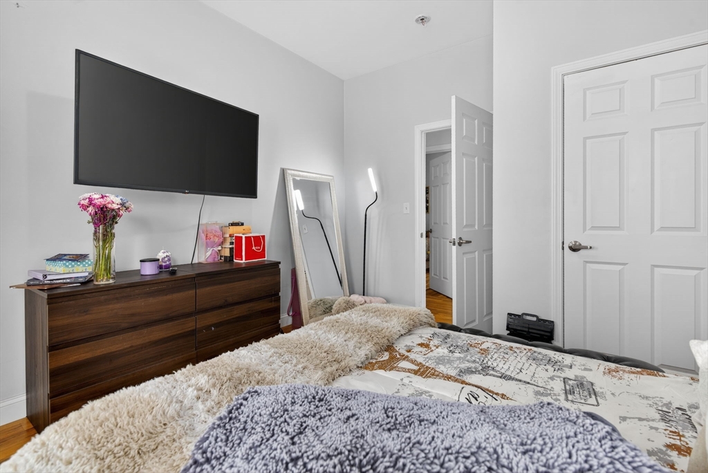 1684 North Shore Road Revere, MA 02151 - Photo 26 of 39 a bed room with a bed and a flat screen tv