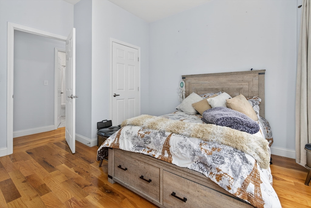 1684 North Shore Road Revere, MA 02151 - Photo 28 of 39 a bedroom with a bed and wooden floor
