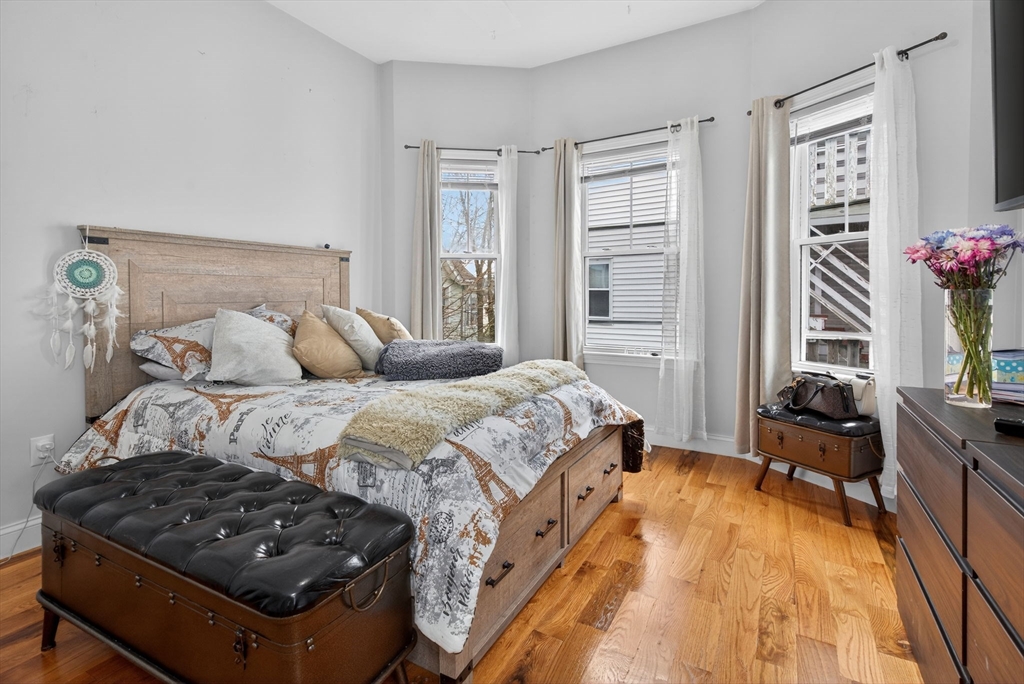 1684 North Shore Road Revere, MA 02151 - Photo 29 of 39 a bedroom with a bed and wooden floor