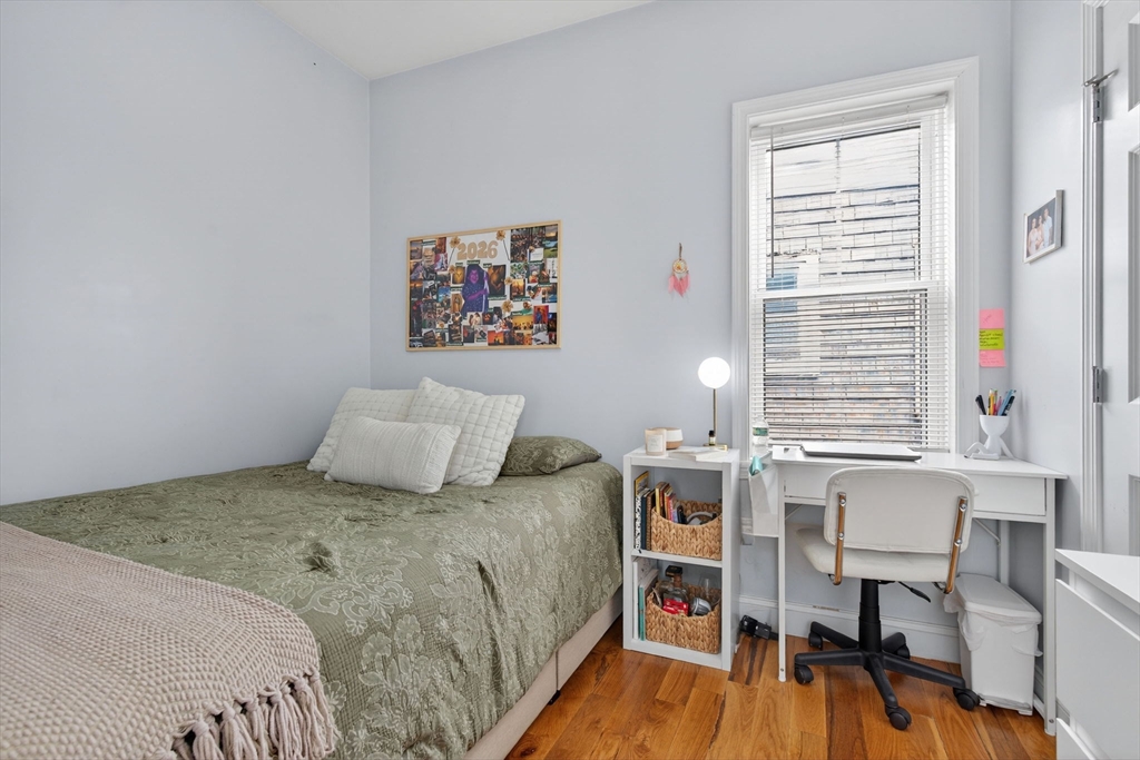 1684 North Shore Road Revere, MA 02151 - Photo 30 of 39 a bedroom with a bed and a table in it