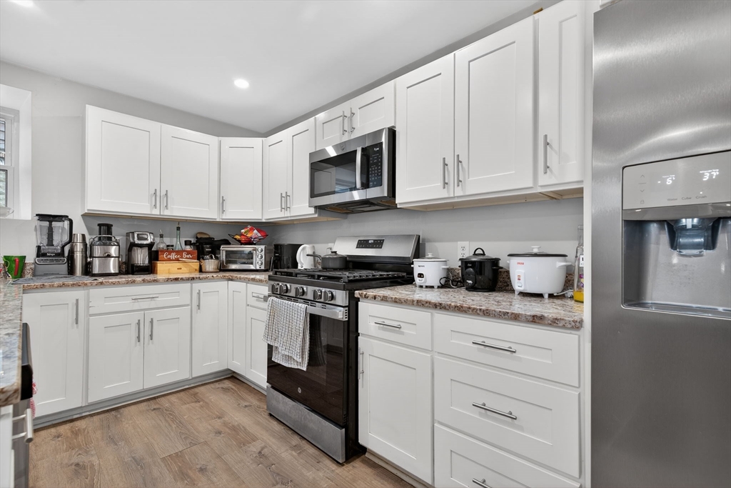 1684 North Shore Road Revere, MA 02151 - Photo 3 of 39 a kitchen with stainless steel appliances granite countertop white cabinets sink and a granite counter top