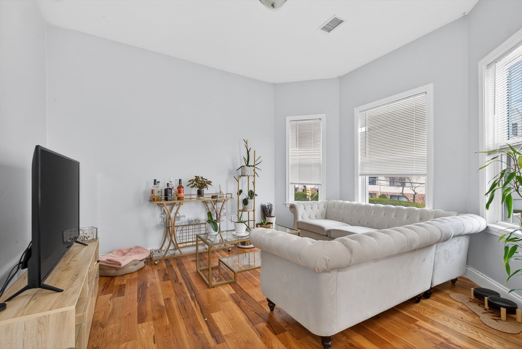1684 North Shore Road Revere, MA 02151 - Photo 32 of 39 a living room with furniture and a flat screen tv