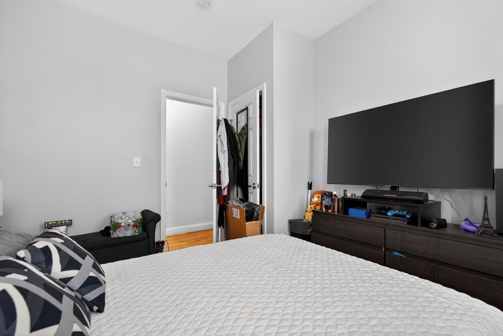 1684 North Shore Road Revere, MA 02151 - Photo 9 of 39 a bedroom with a bed and a flat screen tv