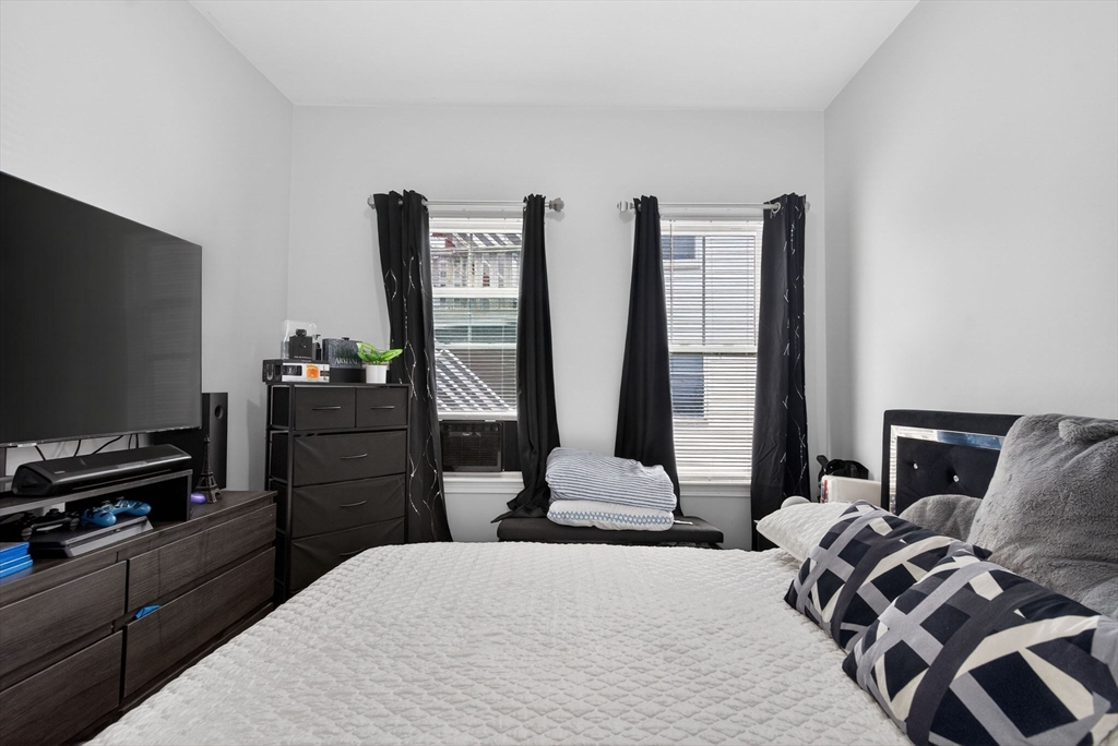 1684 North Shore Road Revere, MA 02151 - Photo 10 of 39 a bedroom with a bed and a flat screen tv