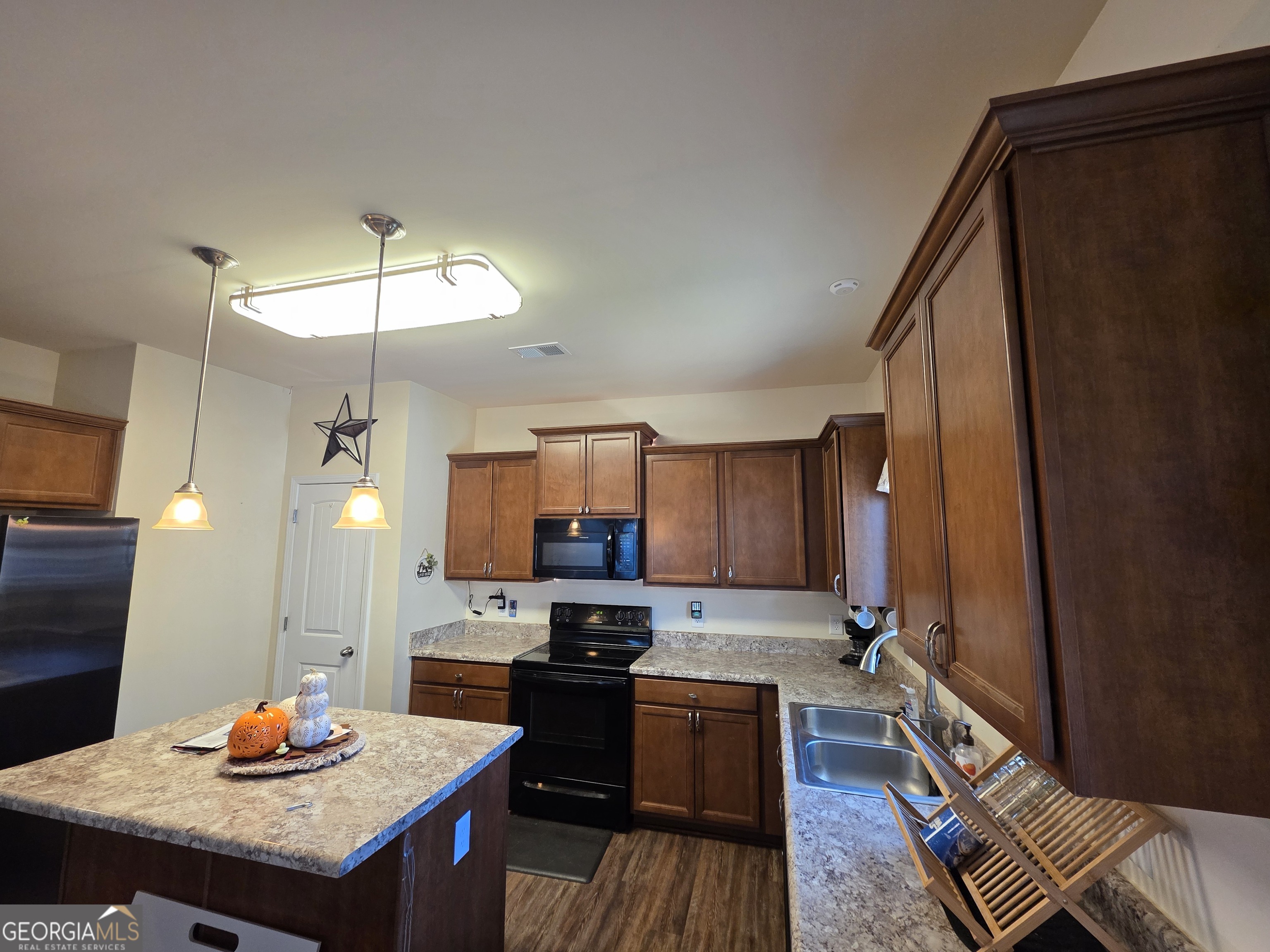 28 Thacker Trail Adairsville, GA 30103 - Photo 14 of 14 a kitchen with stainless steel appliances granite countertop a refrigerator a stove top oven a sink dishwasher and wooden floor