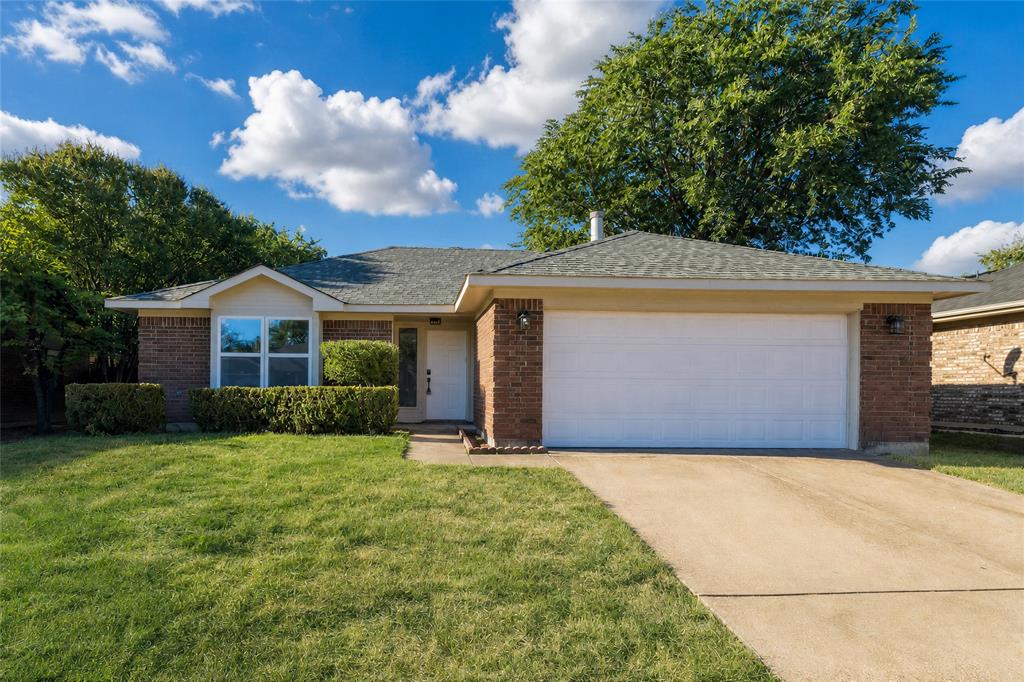 2513 Poplar Spring Road Fort Worth, TX 76123 - Photo 3 of 40 Brick exterior with an attached garage, paved driveway, and a front bay window