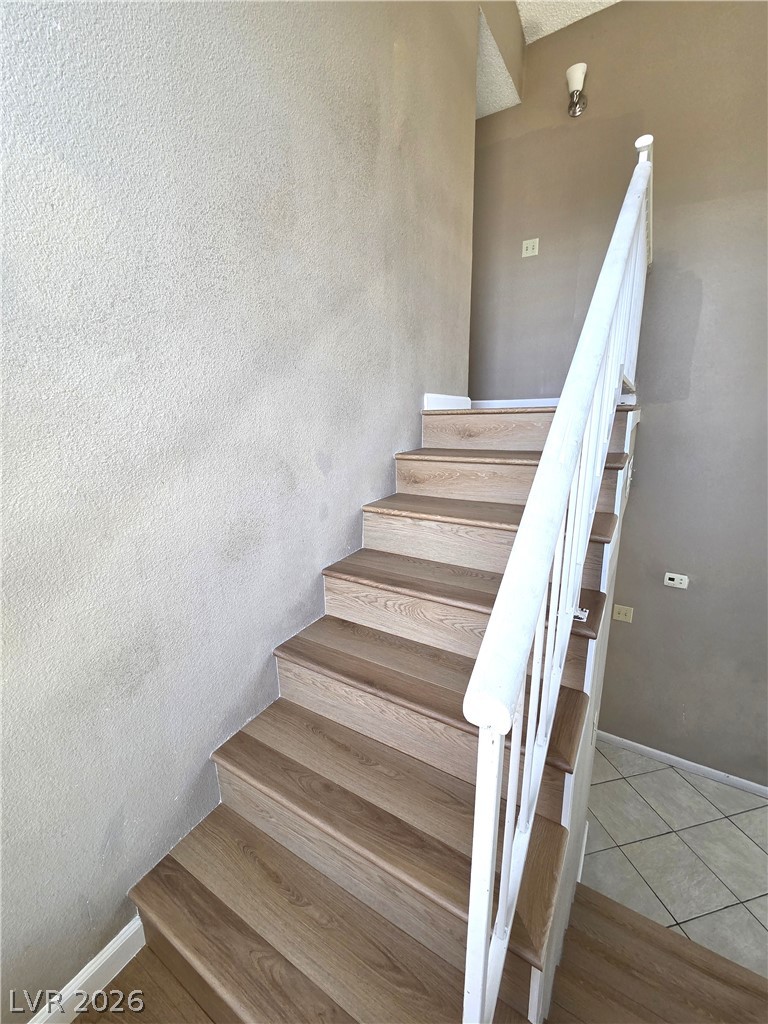 2882 Sandyfalls Way Las Vegas, NV 89142 - Photo 11 of 18 Ascend to comfort on durable, wood-look stair treads, seamlessly connecting living spaces.