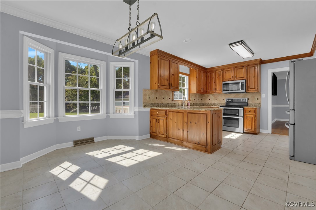 5285 Sandy Valley Road Mechanicsville, VA 23111 - Photo 17 of 37 a kitchen with stainless steel appliances granite countertop a stove a sink and a refrigerator