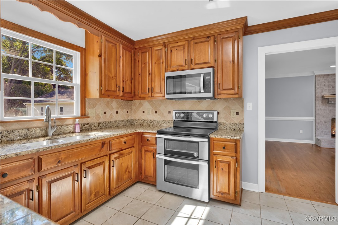 5285 Sandy Valley Road Mechanicsville, VA 23111 - Photo 19 of 37 a kitchen with stainless steel appliances granite countertop a stove a sink and a microwave