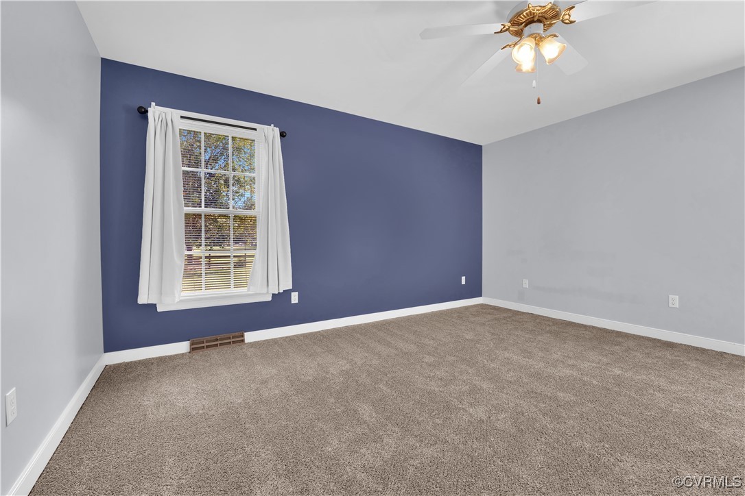 5285 Sandy Valley Road Mechanicsville, VA 23111 - Photo 22 of 37 an empty room with windows and chandelier fan