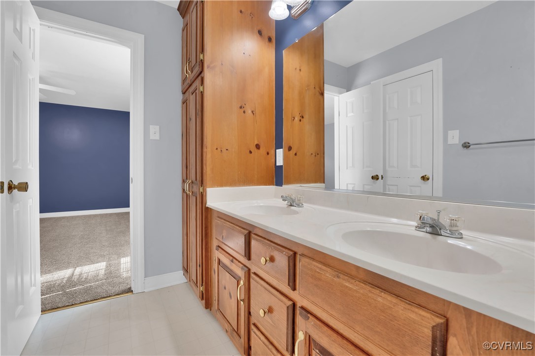5285 Sandy Valley Road Mechanicsville, VA 23111 - Photo 24 of 37 a bathroom with a double vanity sink and a mirror