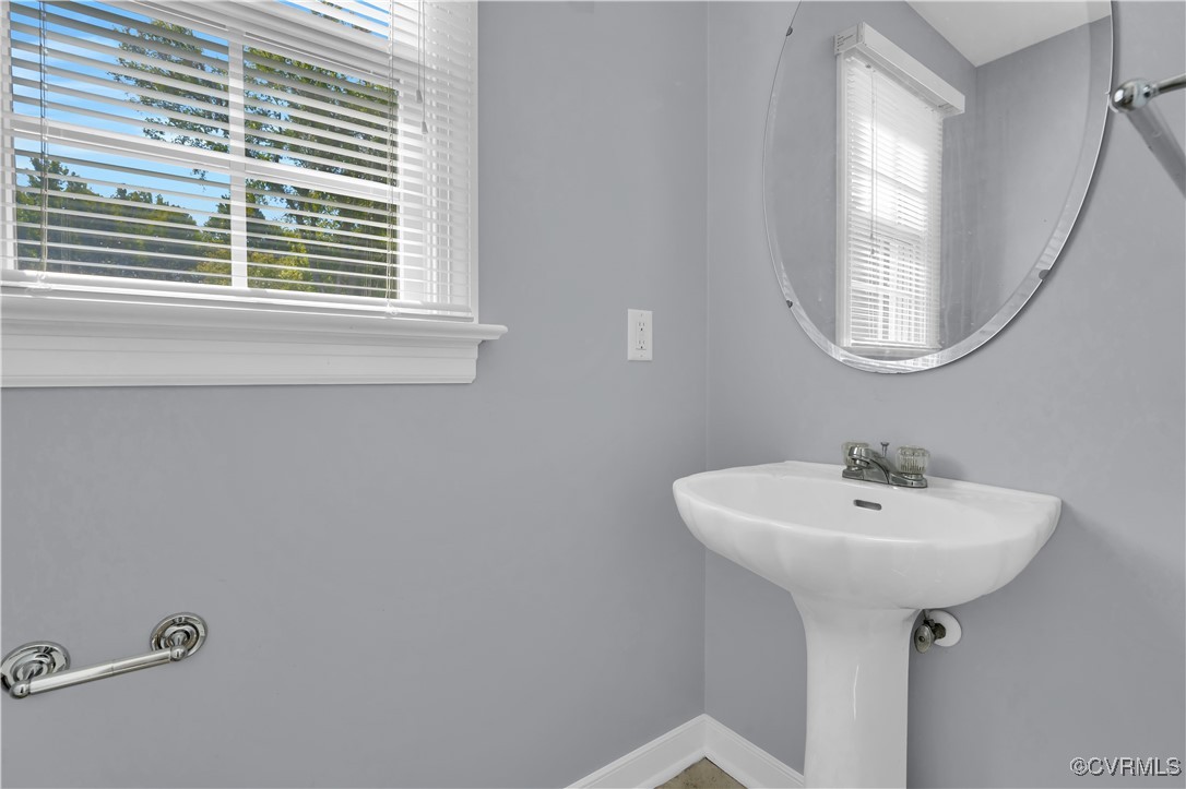 5285 Sandy Valley Road Mechanicsville, VA 23111 - Photo 34 of 37 a bathroom with a sink a mirror and a window
