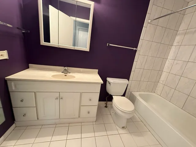 a white toilet sitting next to a bathroom sink