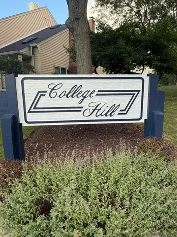 a street sign that is on a brick wall