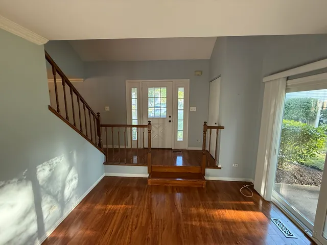 a view of entryway and hall with wooden floor