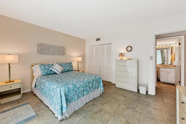 a bedroom with a bed and a view of bathroom