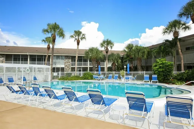 a building outdoor space with patio furniture and potted plants