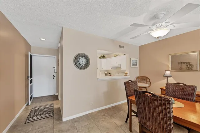 a view of a dining room with furniture and a large mirror