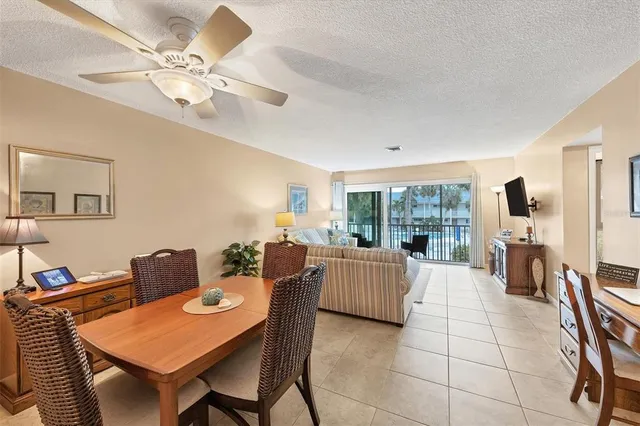 a living room with fireplace furniture and a large window