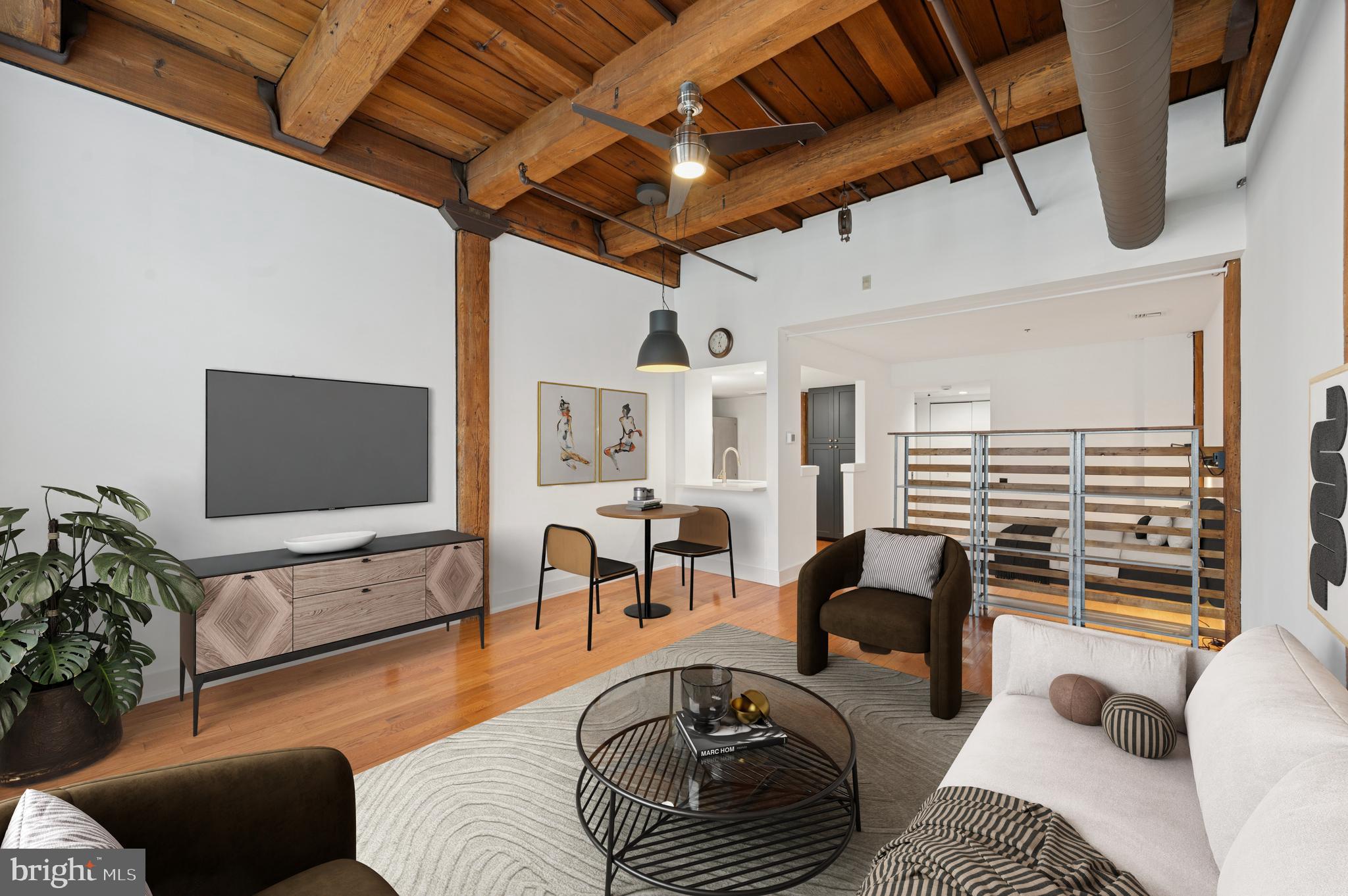 301 Race Street, Unit 308 Philadelphia, PA 19106 - Photo 1 of 17 a living room with furniture a dining table and a flat screen tv with wooden floor