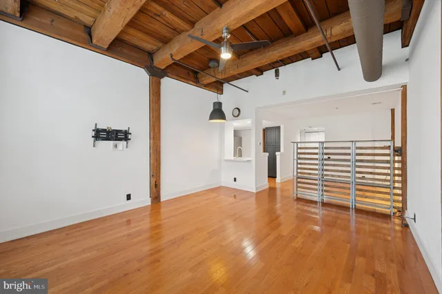 a view of empty room with wooden floor