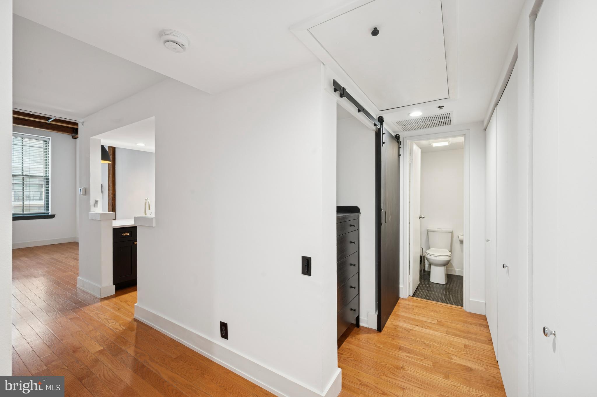 301 Race Street, Unit 308 Philadelphia, PA 19106 - Photo 12 of 17 a view of a hallway with bathroom and wooden floor